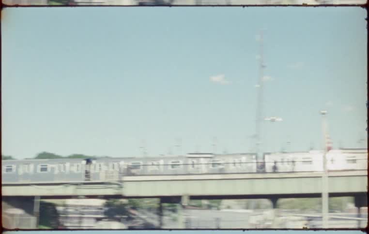 Train travels along metal tracks and carries people to the station