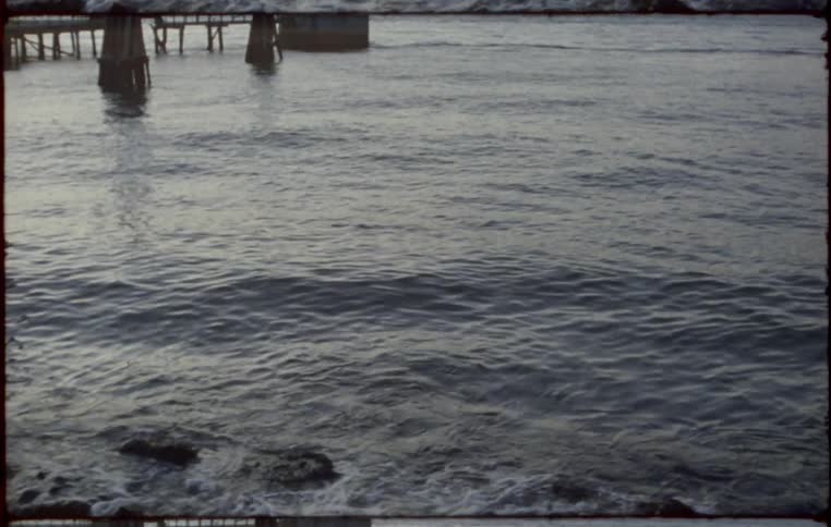 Waves rolls into a rocky shoreline during the evening
