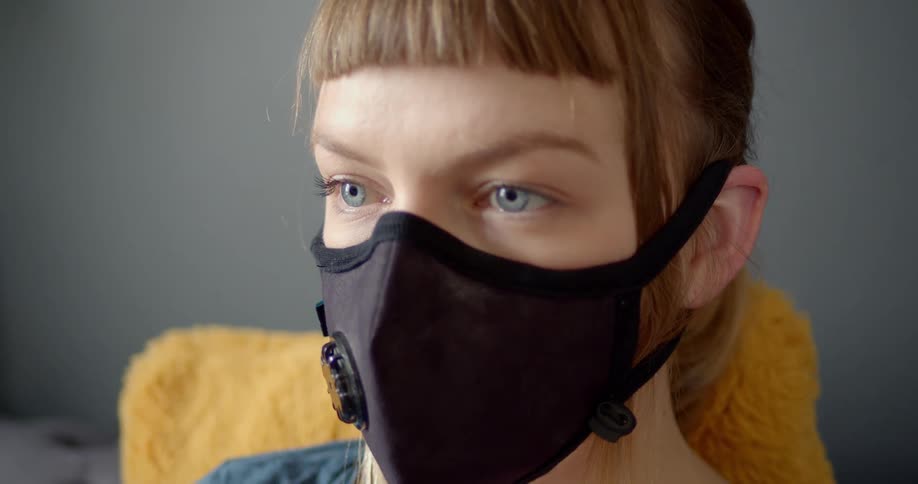 A woman wears a safety mask