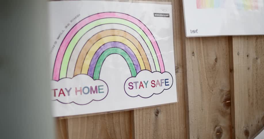 A wooden fence with paper signs attached to it