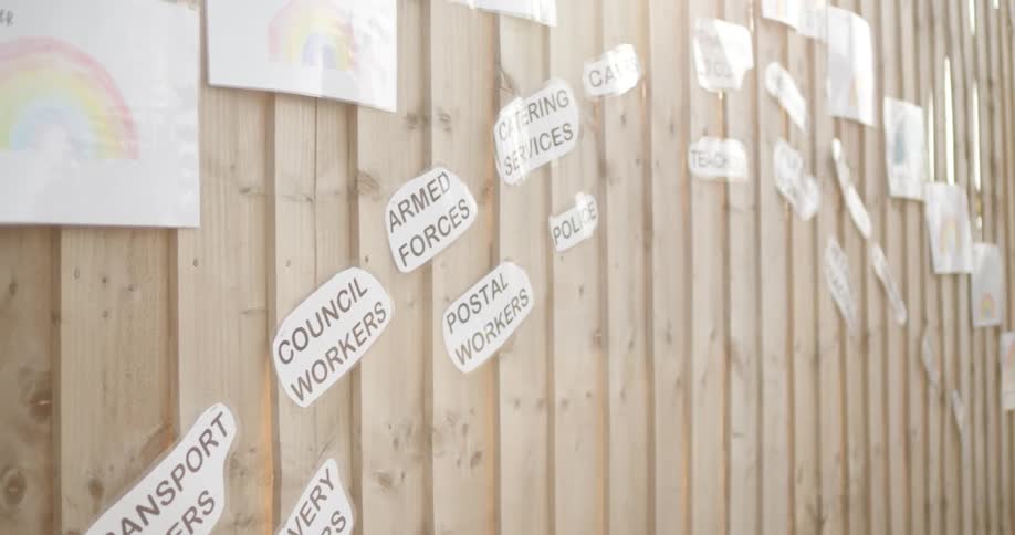 The fence is covered with artwork and signs