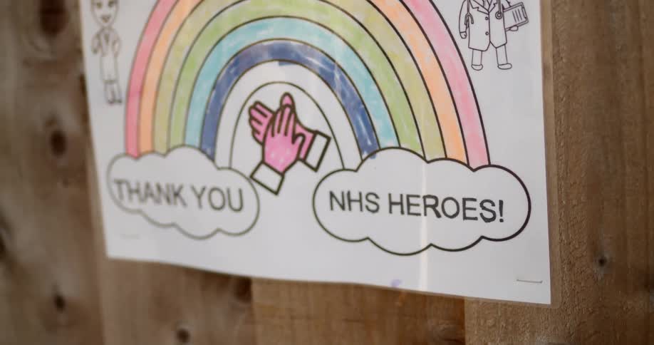 A thank you sign hangs on a fence