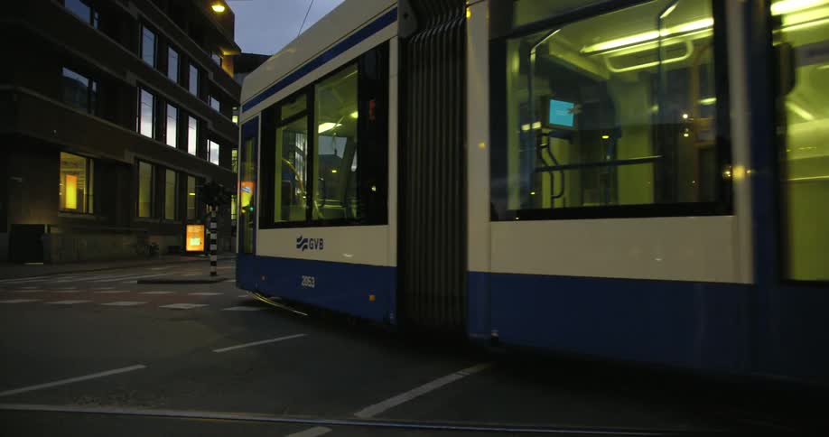 Tram from amsterdam public transport passing on empty street