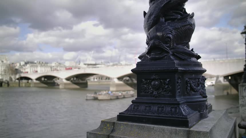 Close up of lamp post base near bridge over river