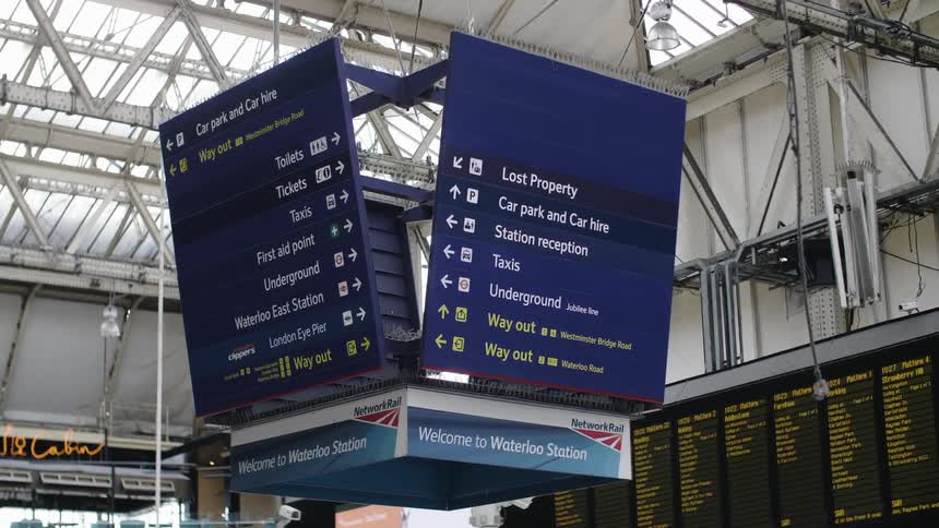 A sign hangs in a station