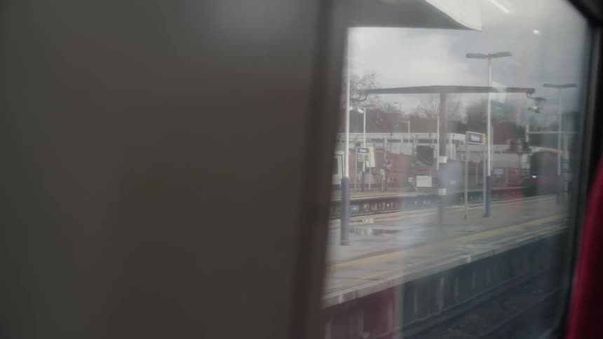 Trains pass each other on either side of transit platform