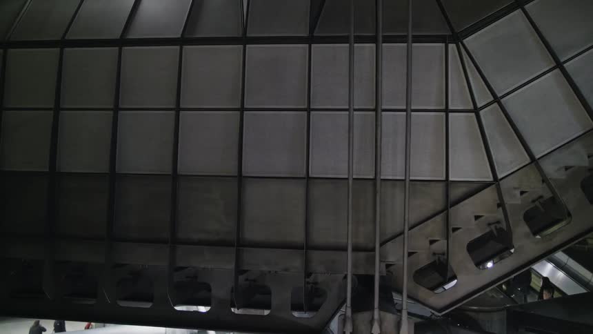 People ride on the escalator in a shopping mall
