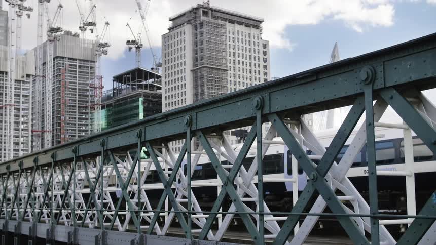 A train crosses a trestle in a city