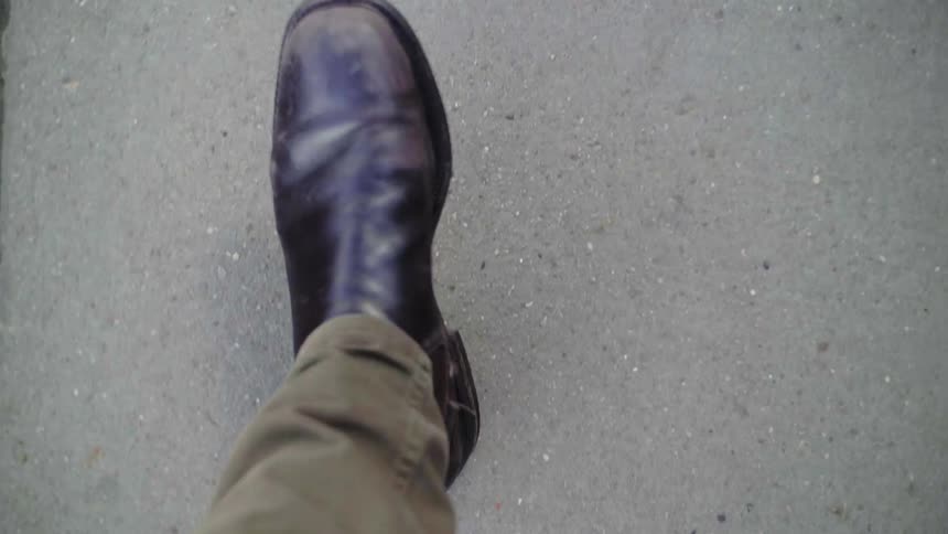 A man is walking on a pathway outdoors