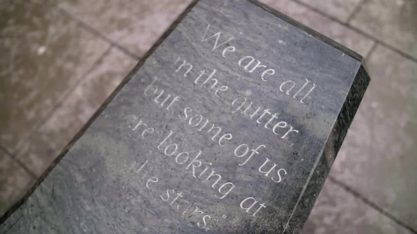 A quote is written on a marble headstone in a mausoleum