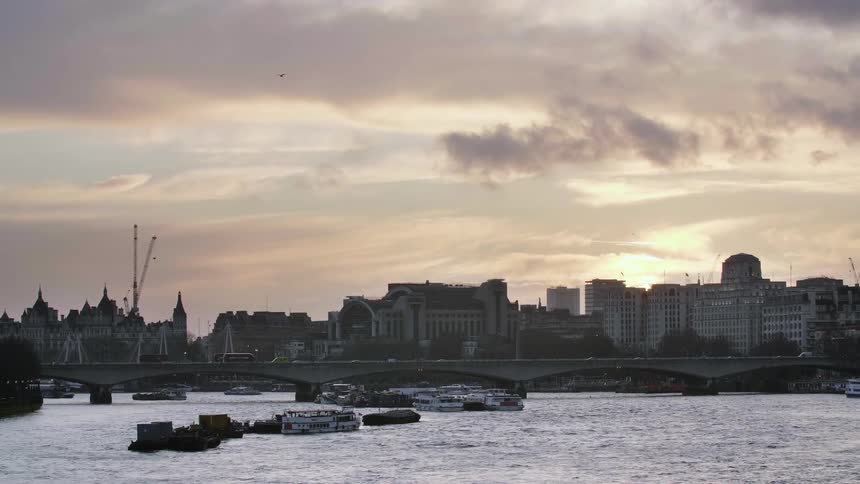 A waterfront bordering a city in the evening