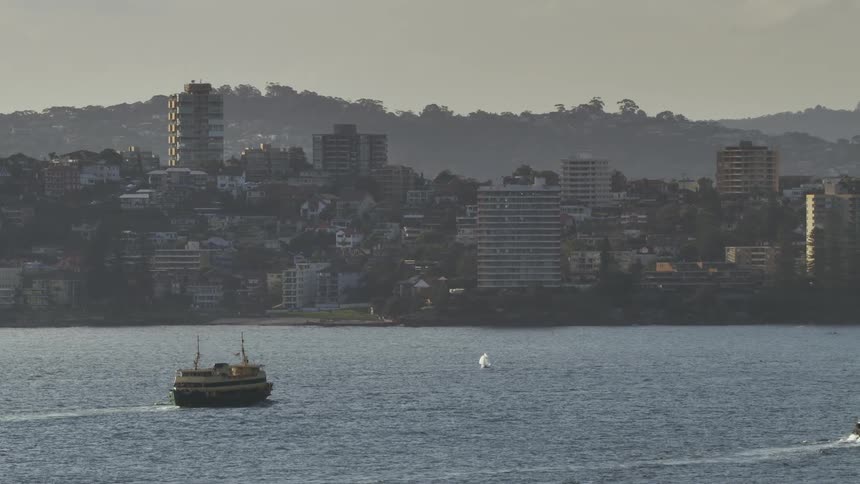 Ferry travels across the sea advancing to the city port