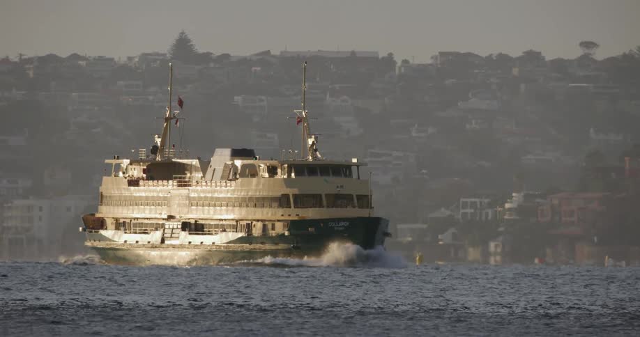 Large ferry boat cruising across the lake on a hazy day