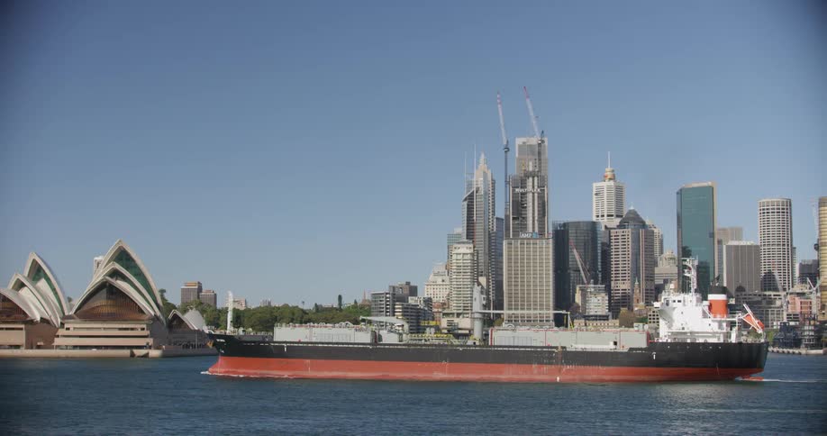 Ship sails on the sea in front of the the sydney opera house
