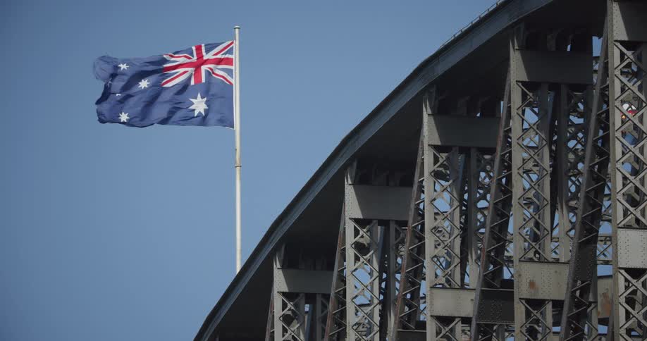 A bridge with the australian flag waving in the wind