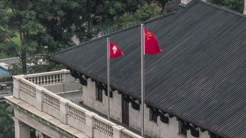 A building with two flags waving in the wind