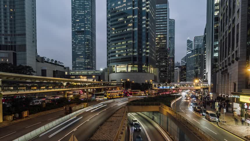 View of the traffic jam on the highway and people walking down the streets in the city timelapse