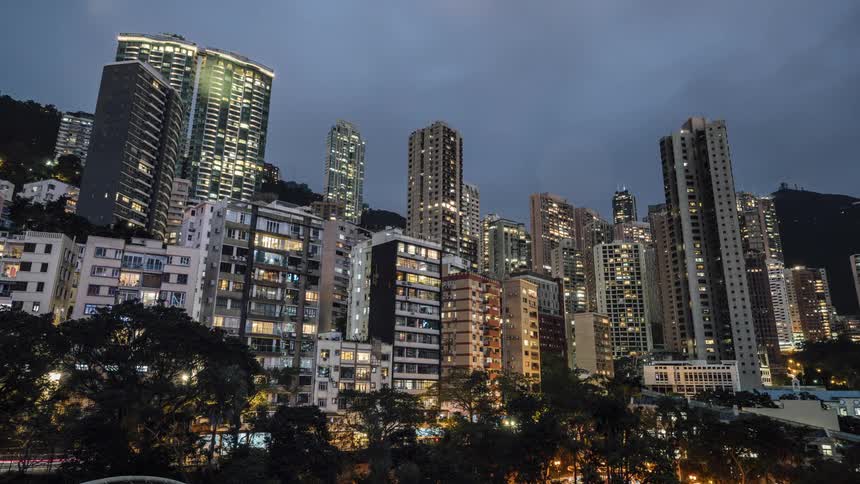 A city with building skyscrapers trees and vehicles