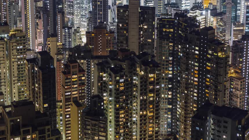 A city with buildings skyscrapers windows and lights