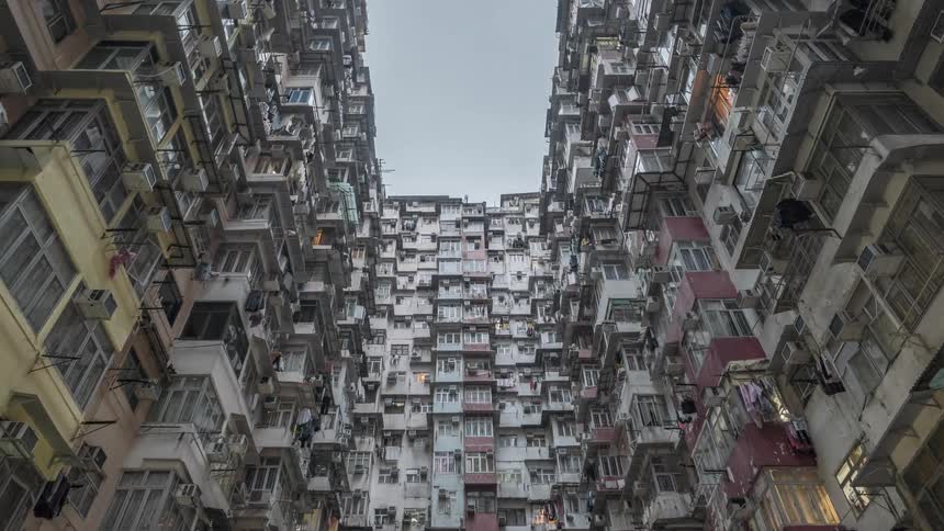 Buildings with windows and air conditioning units with the sky above