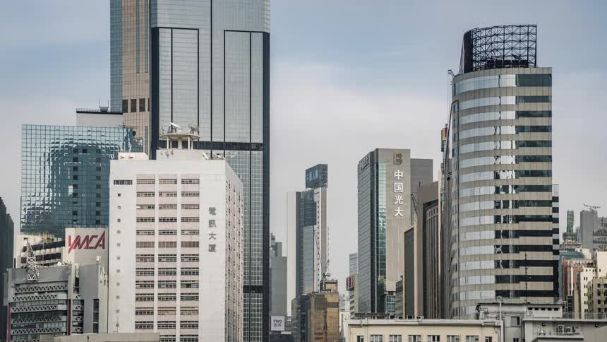 Electronic billboards and building signs flash and change as a rooftop pulley hoists up and down