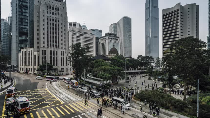 Time lapse of emergency responders monitoring a protest on a busy street