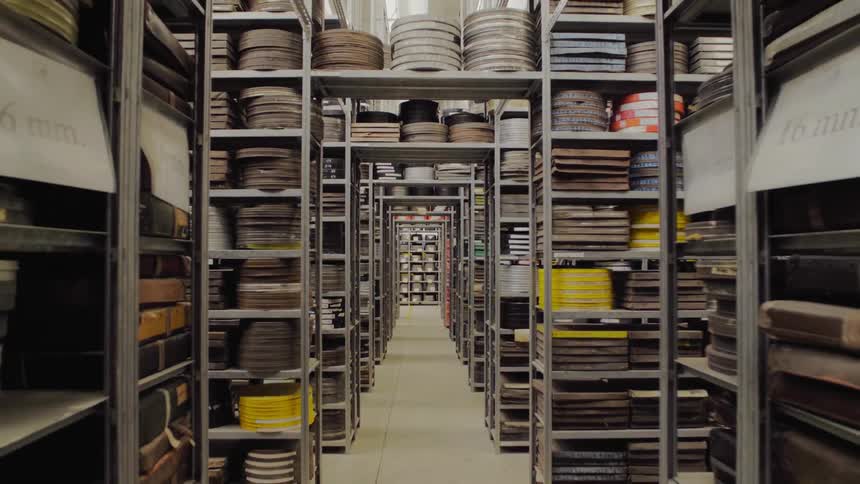 Shelves filled with film containers inside a building