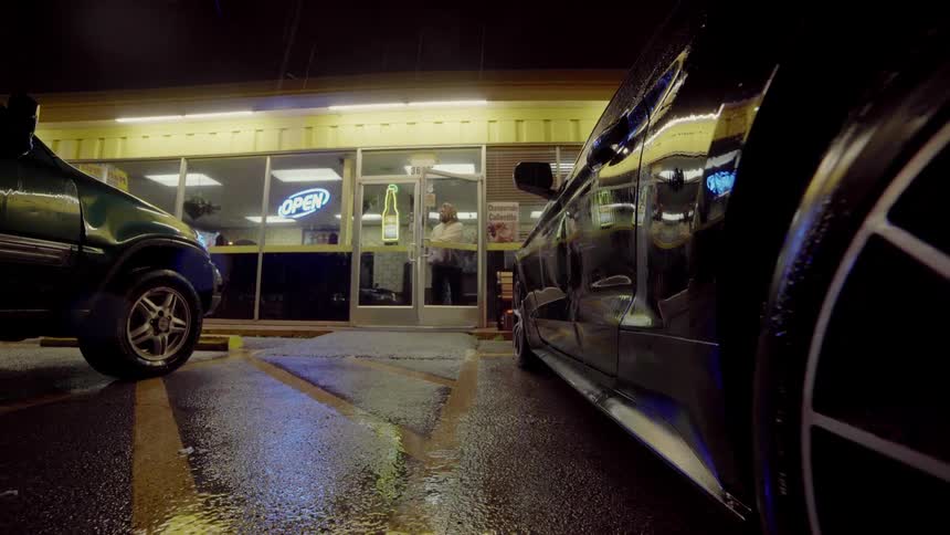 Two men walk out of a restaurant and head to their car