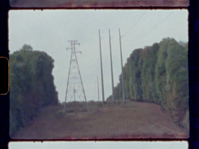 An overhead power line structure next to the lake