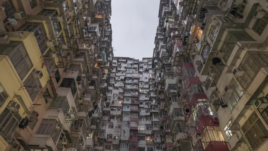 An upward view of monster building with five interconnected buildings in quarry bay hong kong