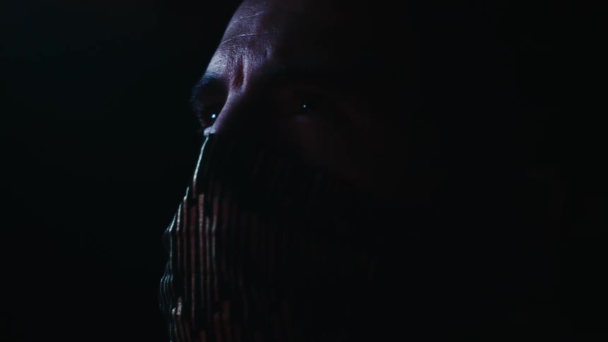 A man with a face mask staring off into the distance