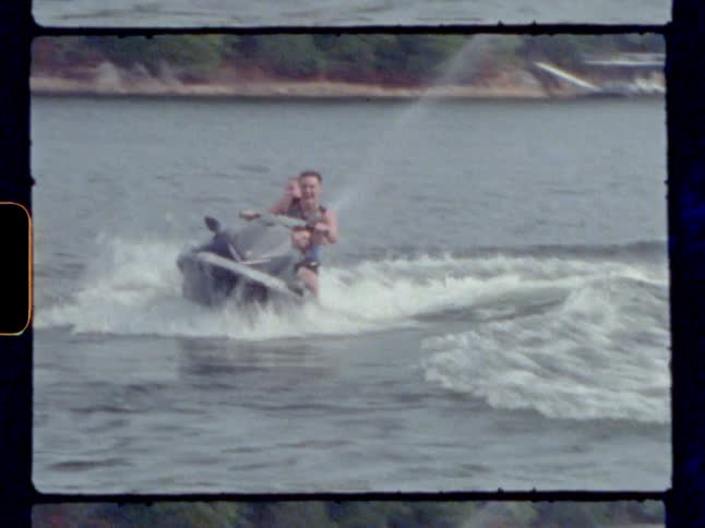 Man and woman travel across water on a jet ski