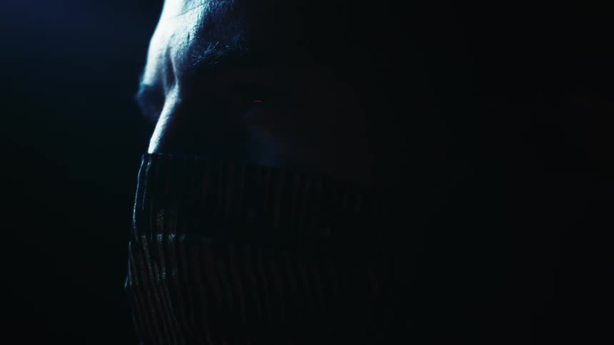 A man putting a face mask over his nose