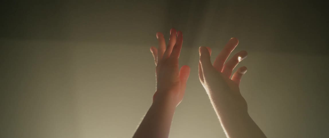 Hands reaching towards the ceiling