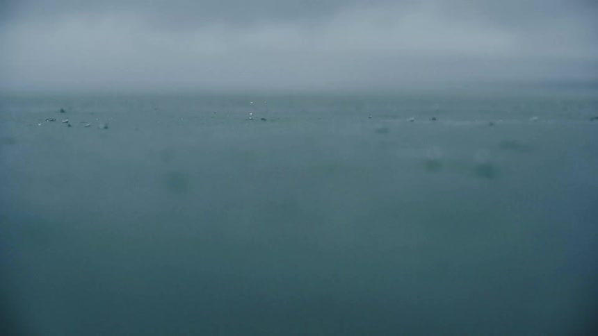 Rain falls on the surface of the ocean