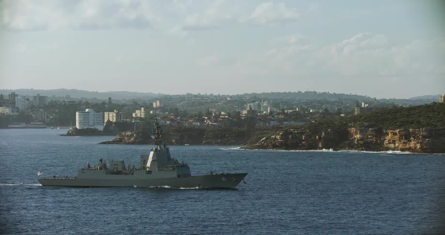 A large ships moves through the water