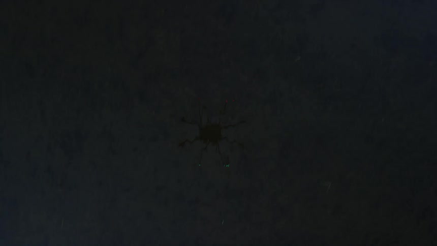 Lights can be seen reflecting off the water below as a spot light passes over
