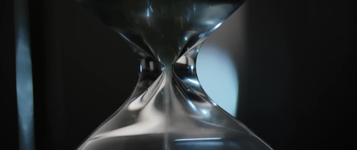 Sand falling through an hourglass