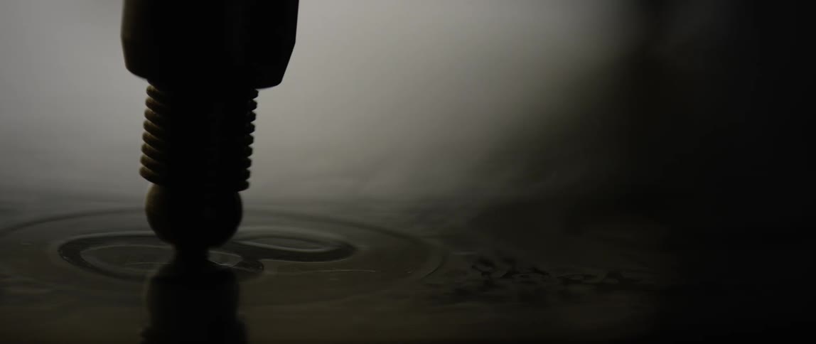 Light and shadow play across the face of a watch or compass