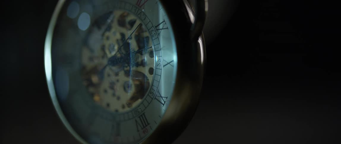 A pocket watch gently swinging