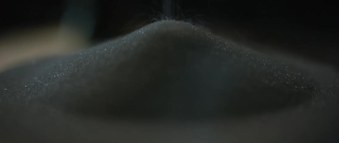 Close up of salt being poured in pile