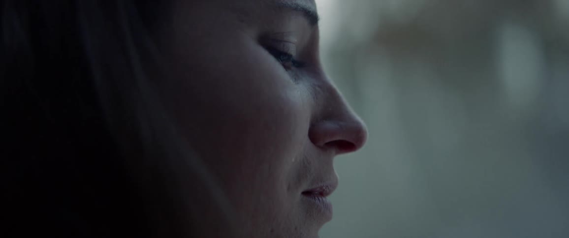 A womans face with the sky in the background
