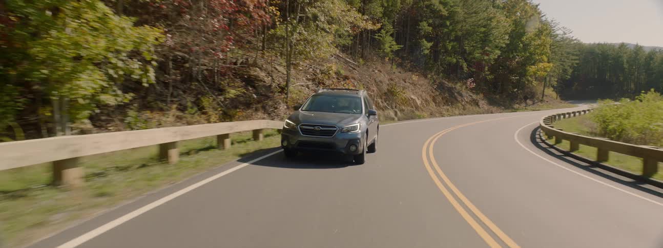 An estate car driven on a mountain road