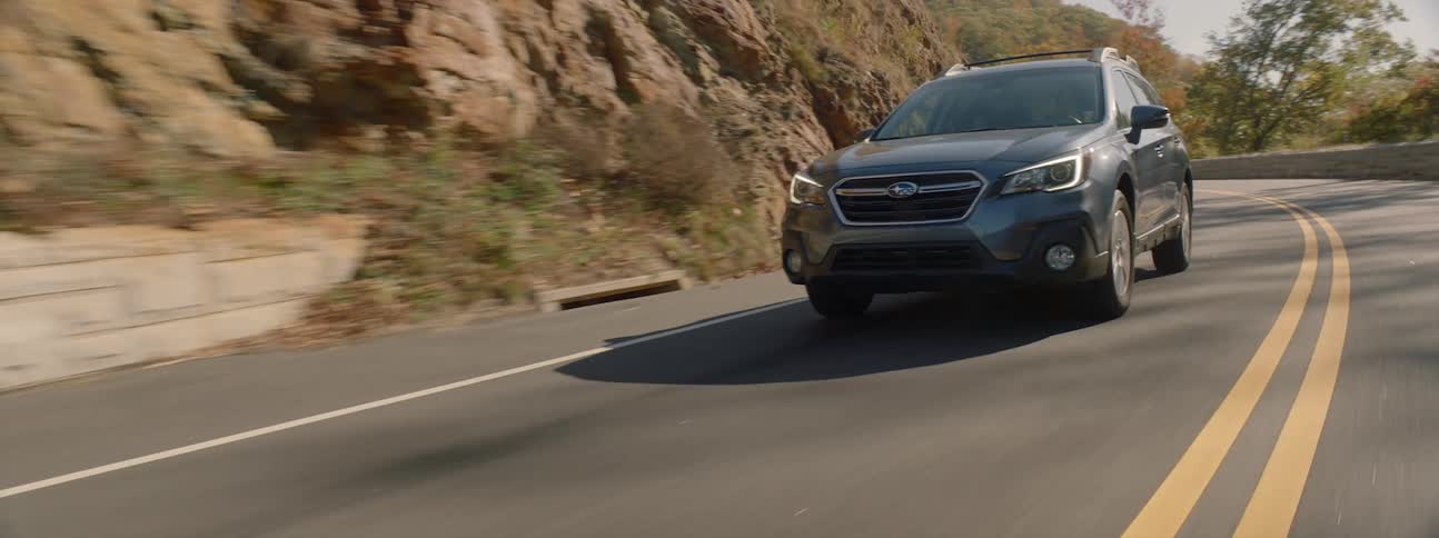 A sports utility vehicle being driven on a mountain road