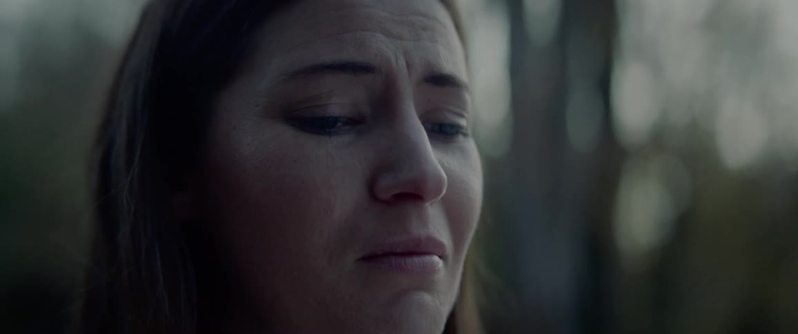 Close up of a sad woman wiping away tears