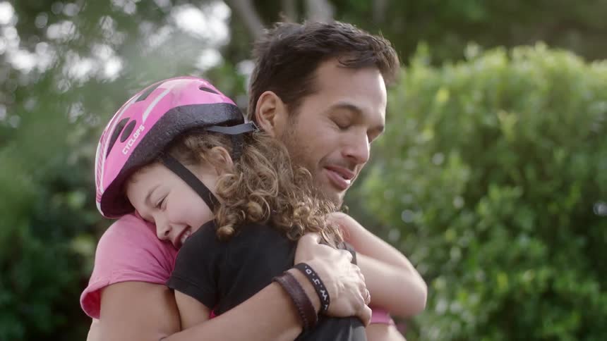 Father cuddles his daughter to show her that he loves her