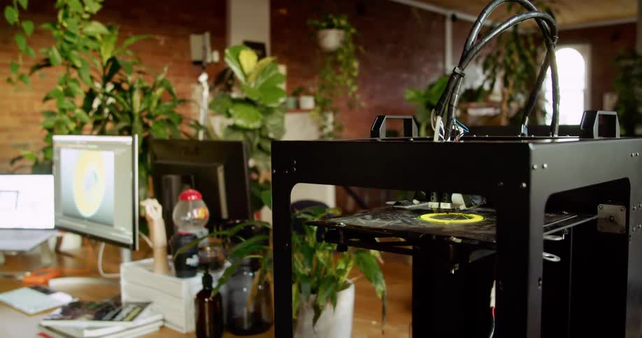 A 3d printer prints an item inside of an office