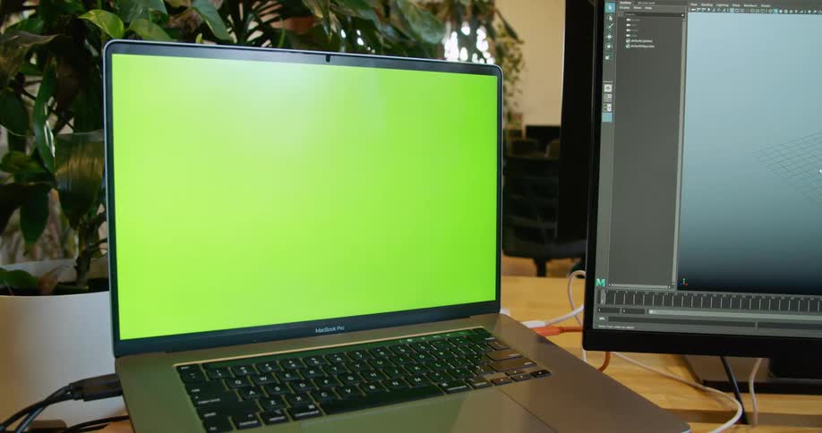 A laptop and separate monitor sit on a desk