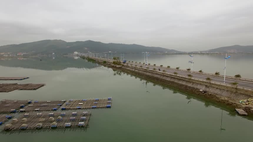 Cars driving a street next to the water