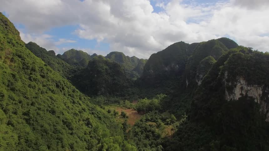A valley is shown in between grassy mountains